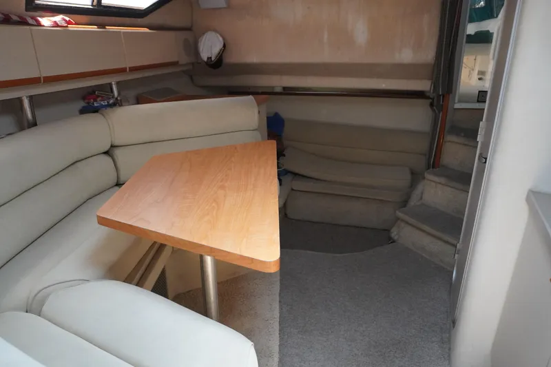 Interior of 1996 Wellcraft 3200 Martinique with seating area and table.
