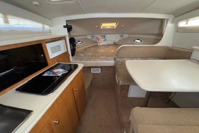 2001 Bayliner 2855 Ciera cabin interior with kitchenette, dining area, and sleeping quarters.