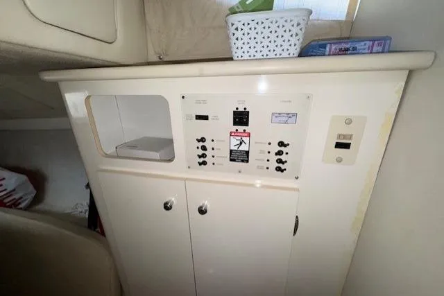 2001 Bayliner 2855 Ciera cabin interior with control panel and storage.